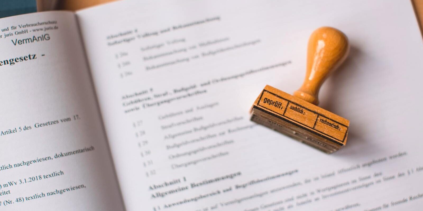 Close-up of a legal document with a wooden stamp placed on top, highlighting verification.